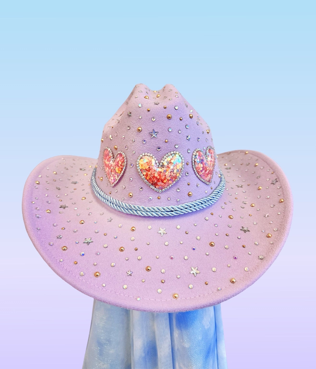 Angled view of lavender sweetheart cowboy hat with sparkling heart embellishments.