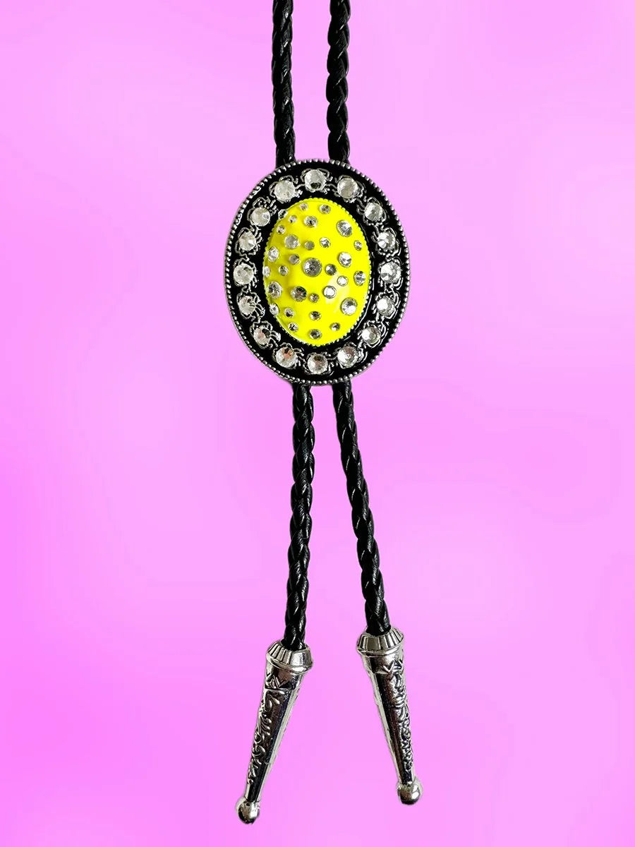 Full front view of the Lemon Glow Bolo Tie with yellow rhinestone pendant and engraved silver tips.