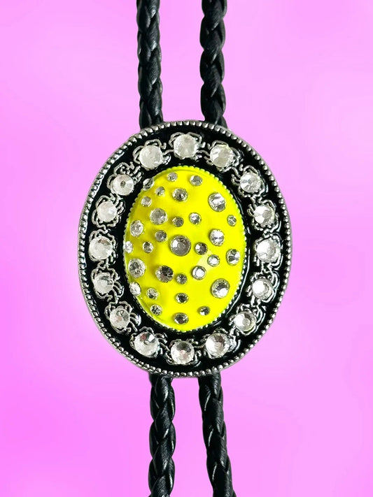 Close-up of the Lemon Glow Bolo Tie pendant with vibrant yellow paint and clear rhinestones.