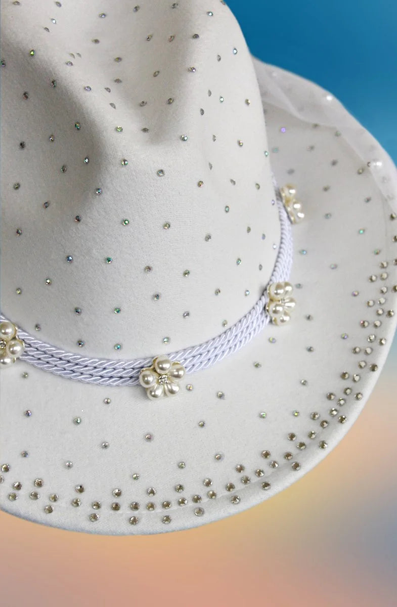 Brim with rhinestones on white cowboy hat.