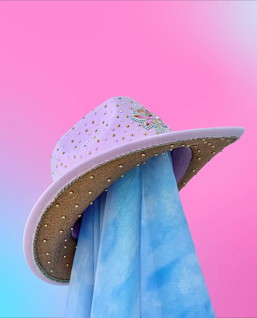Lucky Lotus cowboy hat in peachy pink with neon green cord hat band, side angle.