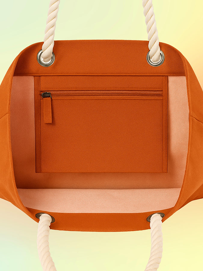 Interior of the Luna Mesa Tote showing zippered pocket, canvas lining, and sturdy rope handles.
