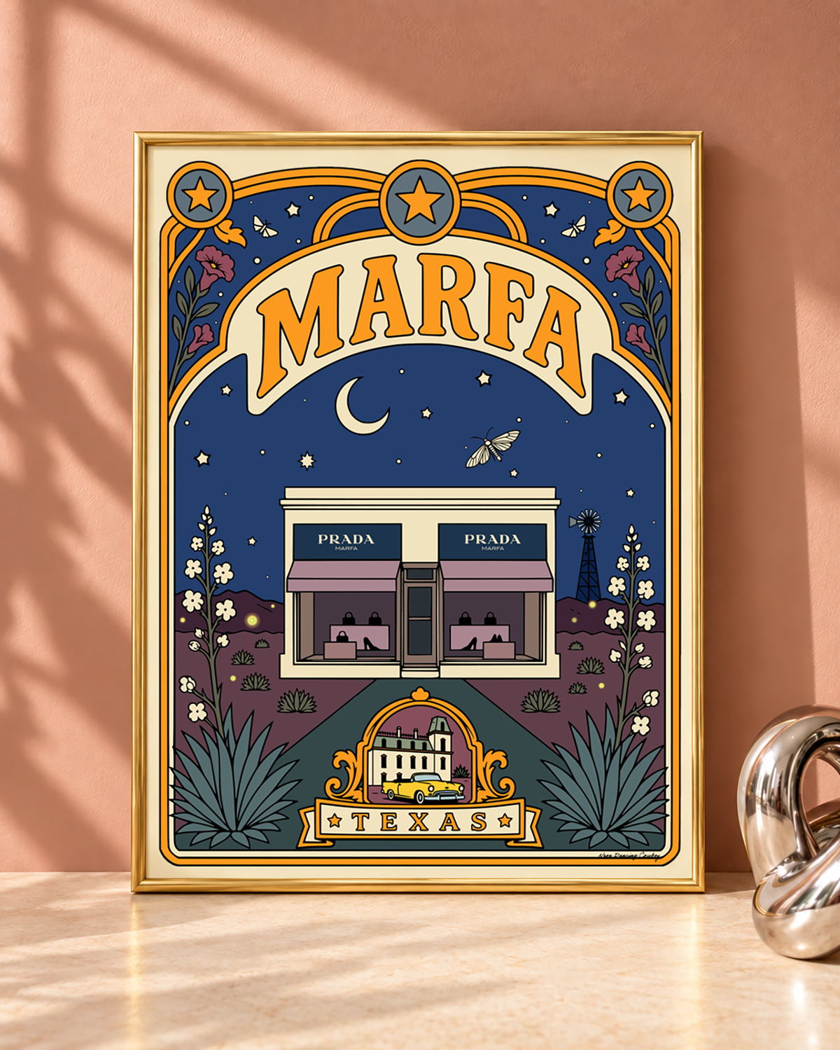 Marfa Texas art print displayed in a slim modern gold frame against a dusty blush wall.