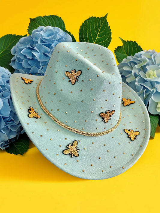 Front angled view of mint green bee-themed cowboy hat with gold embellishments.