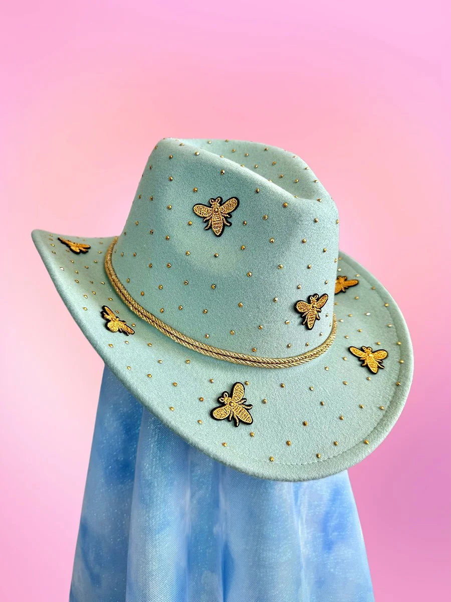Mint green cowboy hat with gold bee appliqués and rhinestone detailing on the crown and brim.