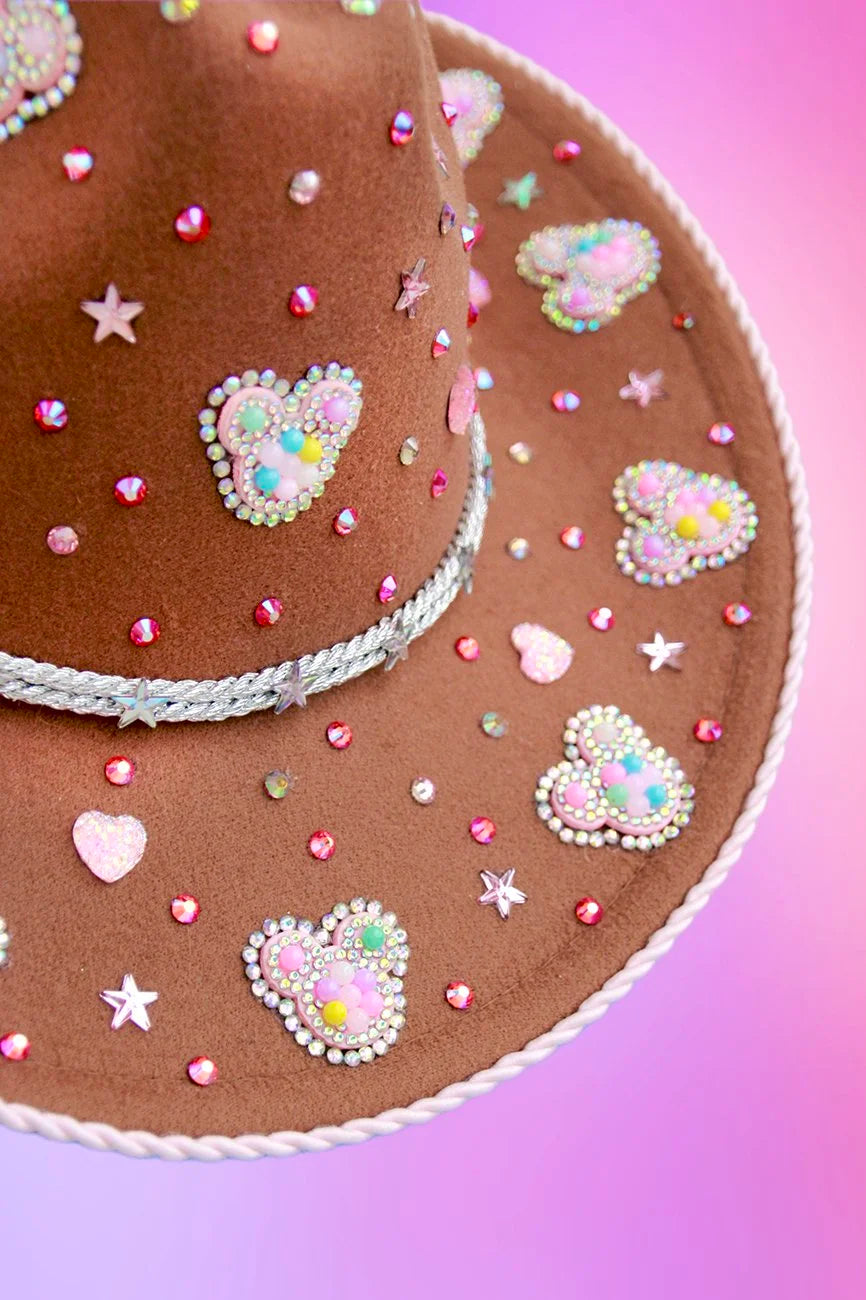 Detail view of rhinestones and Mickey Mouse motifs on cowboy hat.