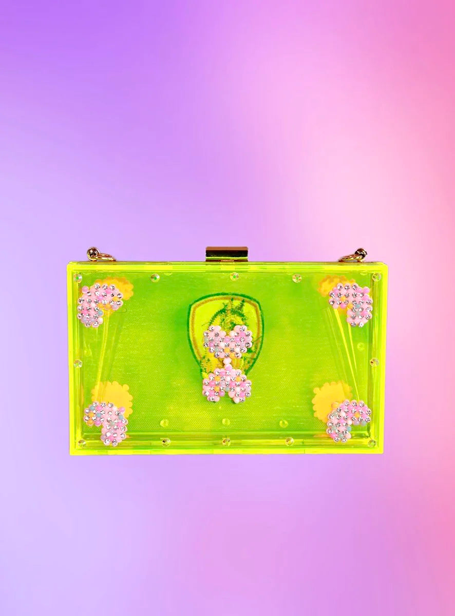 Back view of neon-green acrylic clutch with rhinestone floral clusters and translucent body.