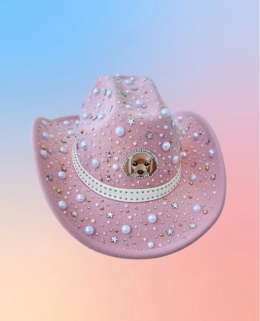 Pink cowboy hat with pearl accents, rhinestones, and puppy embroidery, front view.