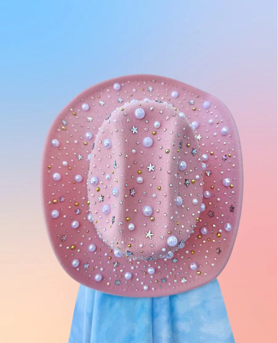 Pink cowboy hat with pearls and stars, full brim view.