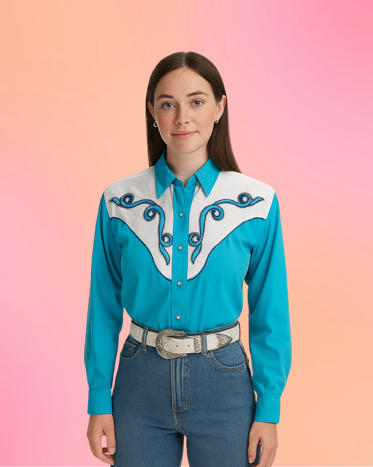 Model wearing teal Rodeo Queen western shirt with white embroidered yoke and pearl snap front.
