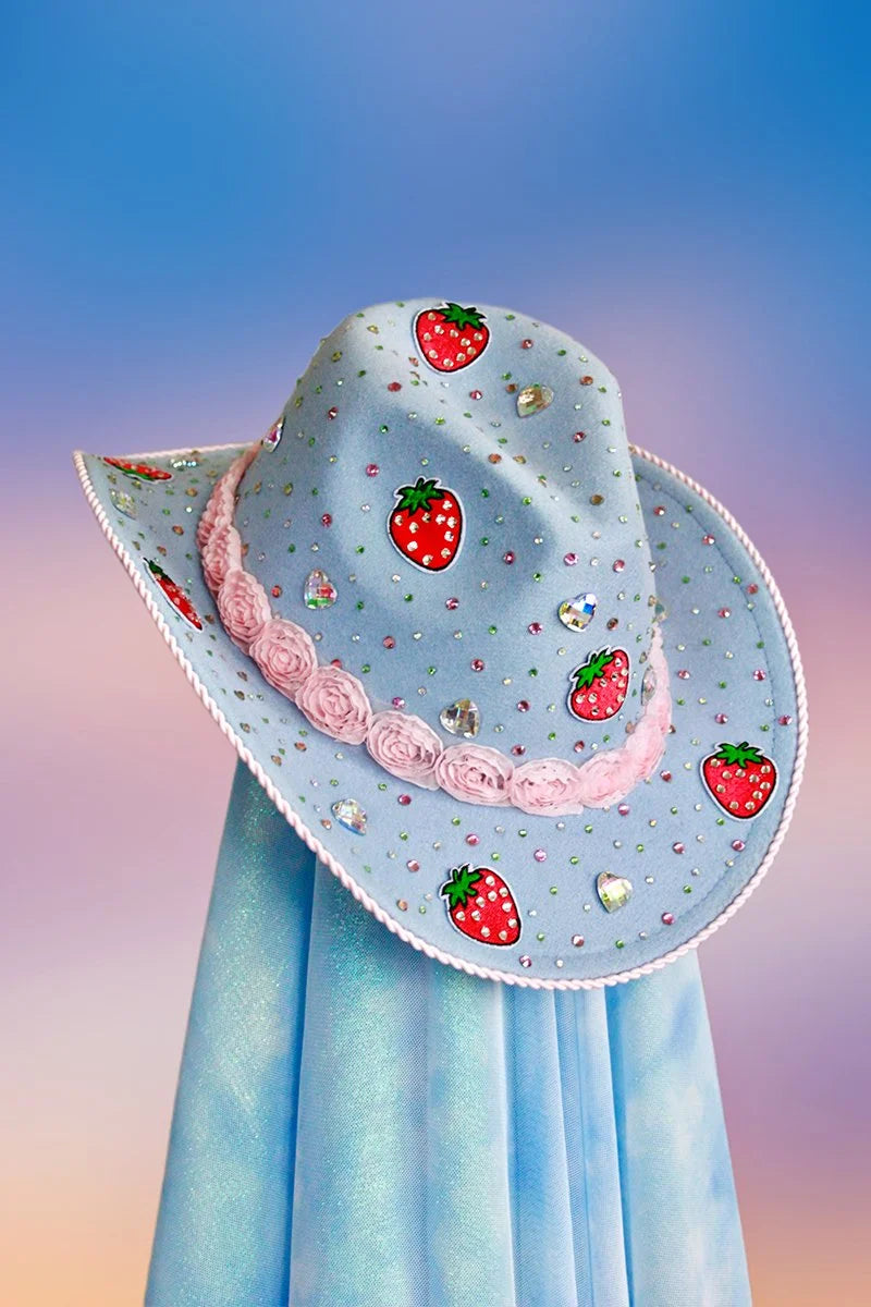Front view of the Strawberry Shortcake cowboy hat in powder blue with strawberry rhinestone motif and pink rose trim.
