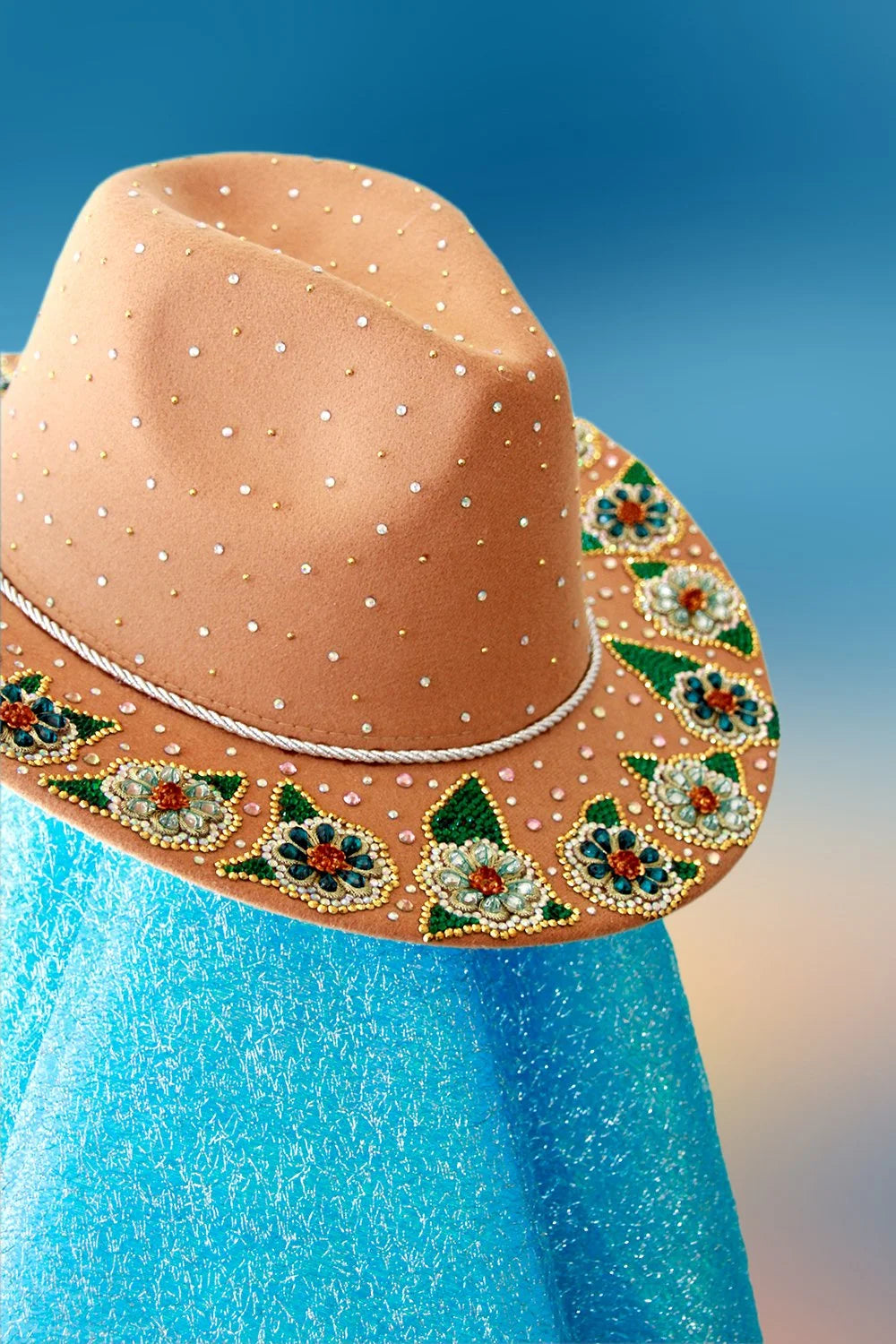 Side angle of tan fedora with rhinestones and colorful beaded floral details.