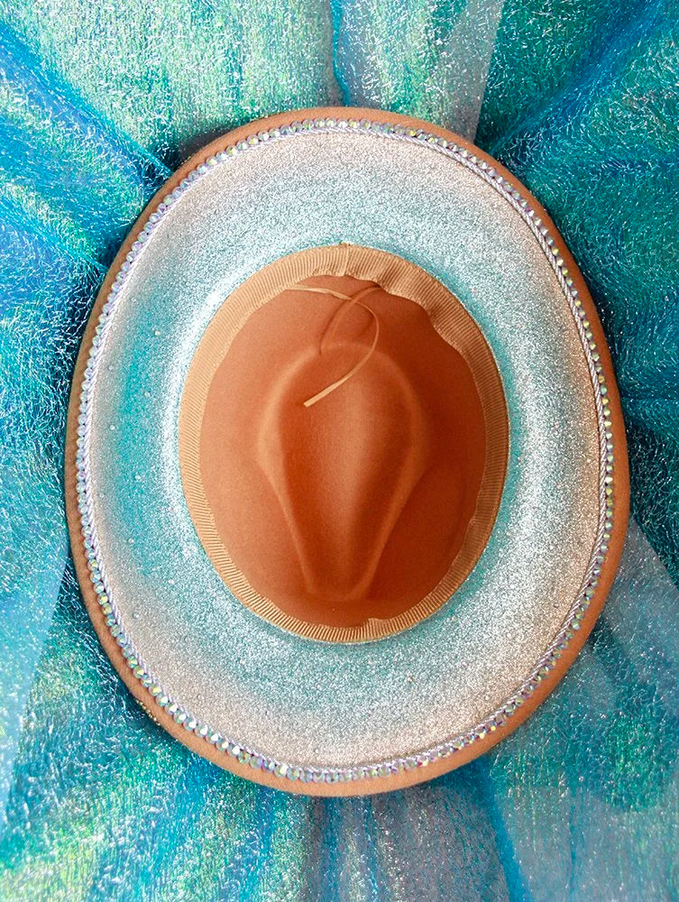 Interior view of camel fedora featuring green, gold, and teal beaded flower designs.