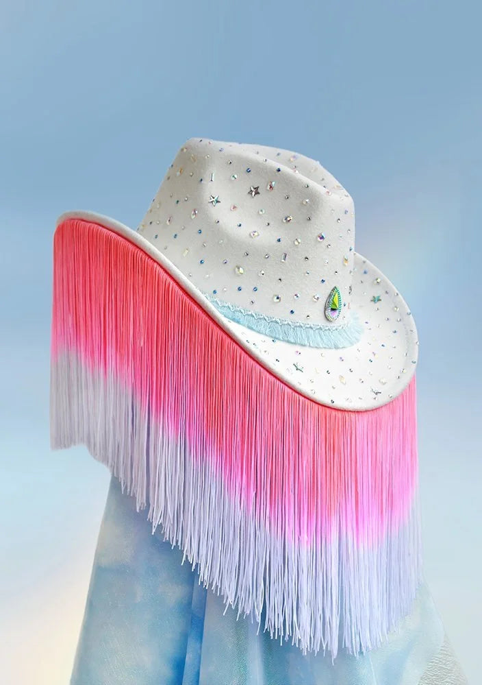 Side view of white showgirl cowboy hat with colorful gems and long fringe.