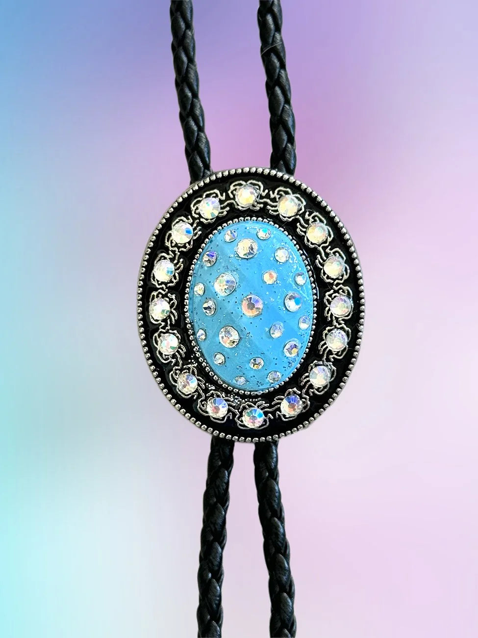 Close-up of the Skyward Bolo Tie pendant with sky-blue paint and iridescent rhinestones.