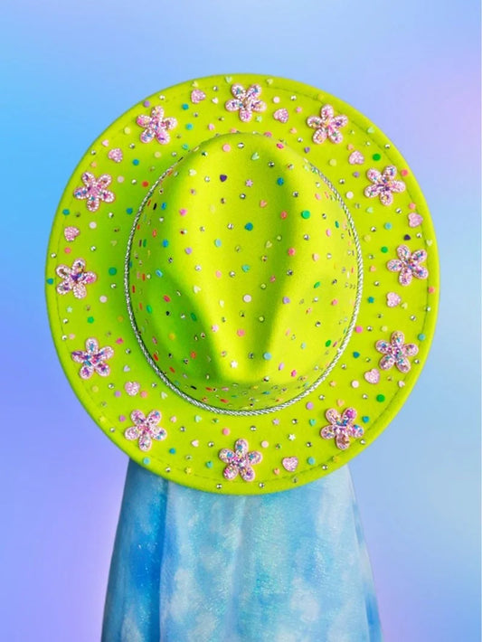 Front view of brightly embellished lime green fedora with playful floral accents.