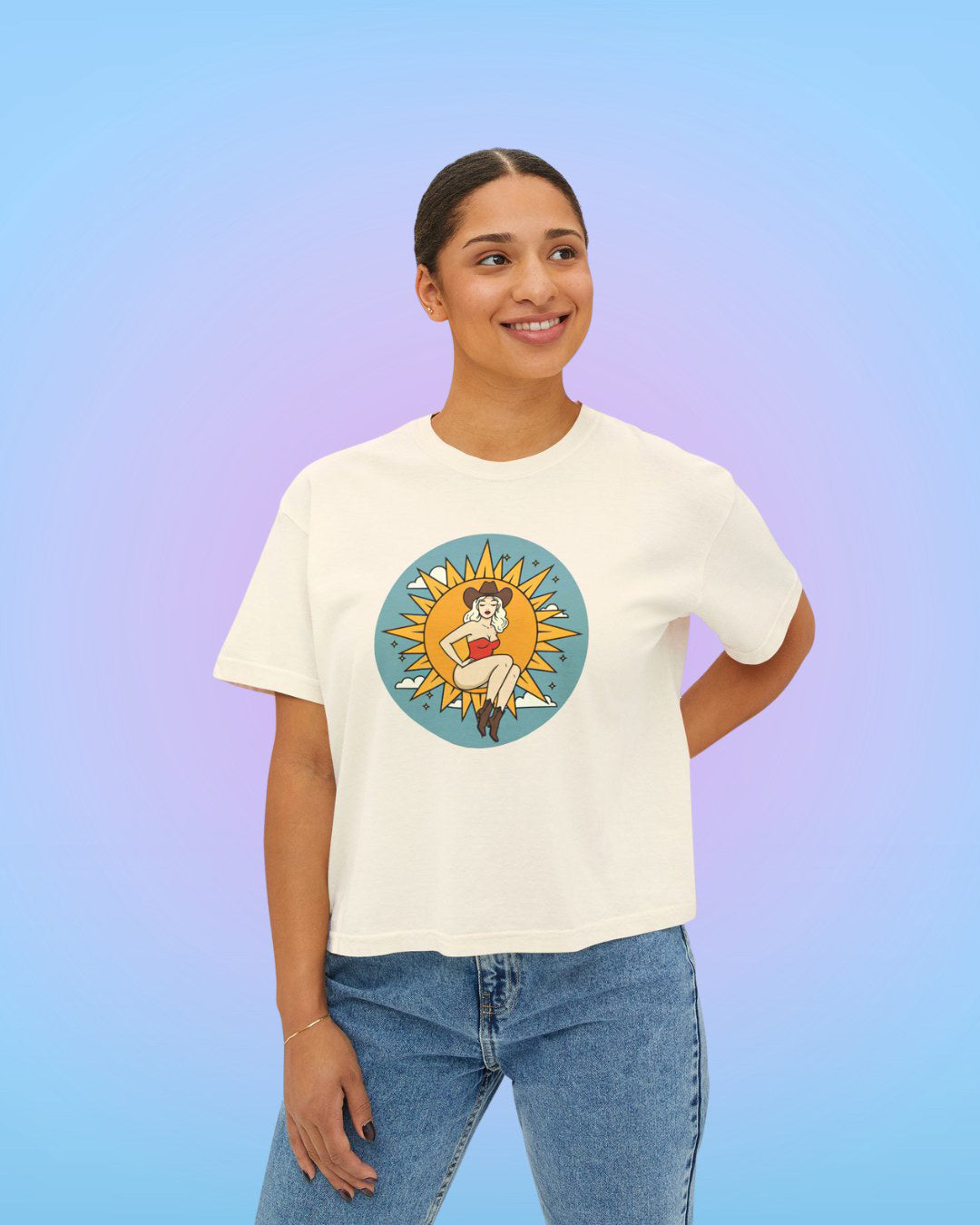 Model wearing ivory Sun Goddess cropped tee with vintage-inspired illustrated artwork.