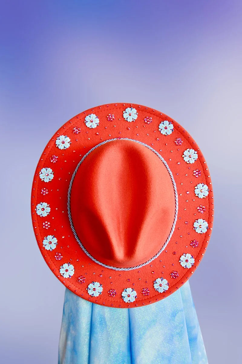 Top-down view showing a full ring of blue and pink floral embellishments around the brim.
