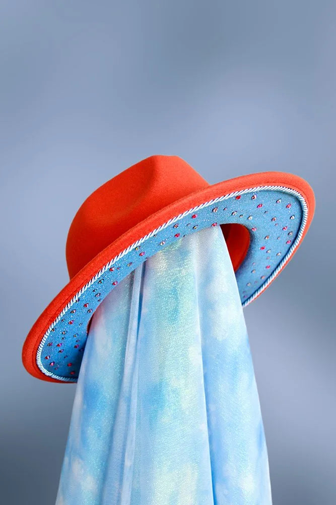 Underbrim view of orange fedora with blue glitter brim and scattered rhinestones.