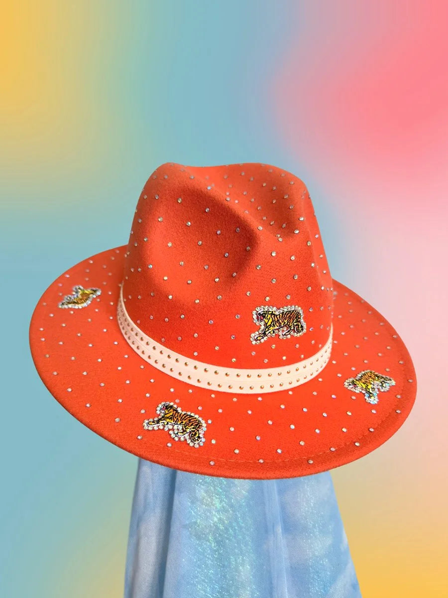 Sunset Prowl Fedora in bright orange with rhinestones and sequin tiger patches, shown at a 3/4 angle.
