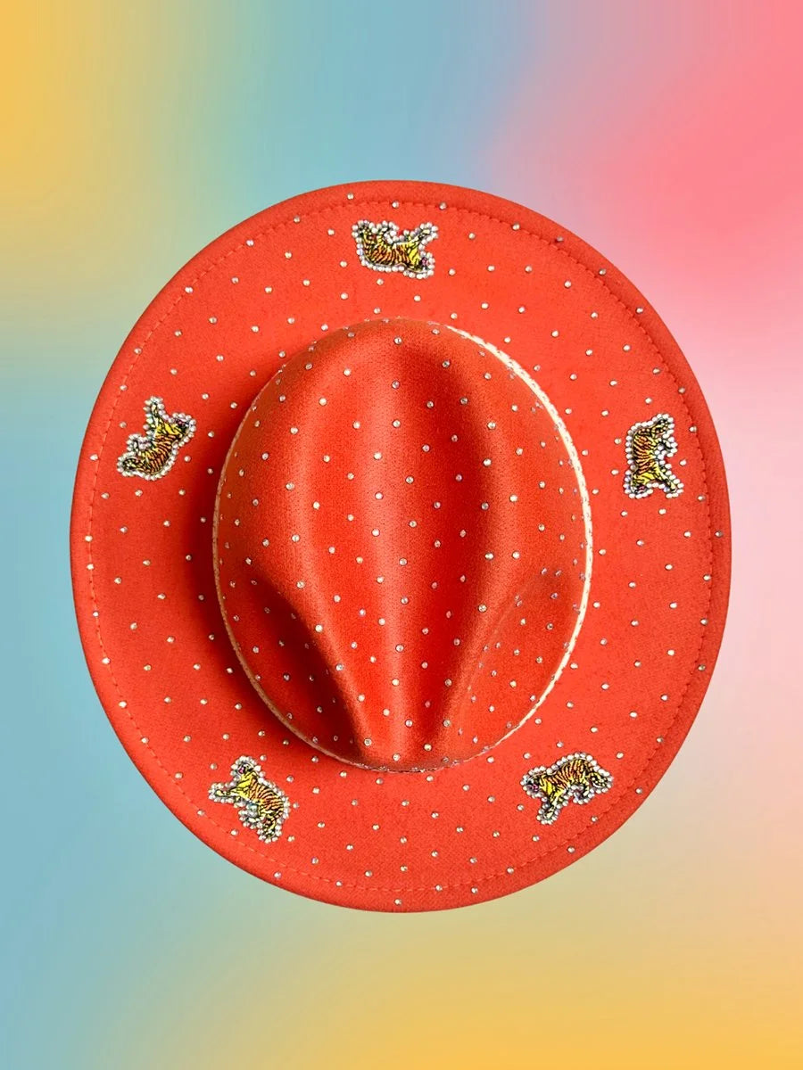 Top view of the Sunset Prowl Fedora showing its rhinestone-studded brim and tiger embellishments on an orange felt base.