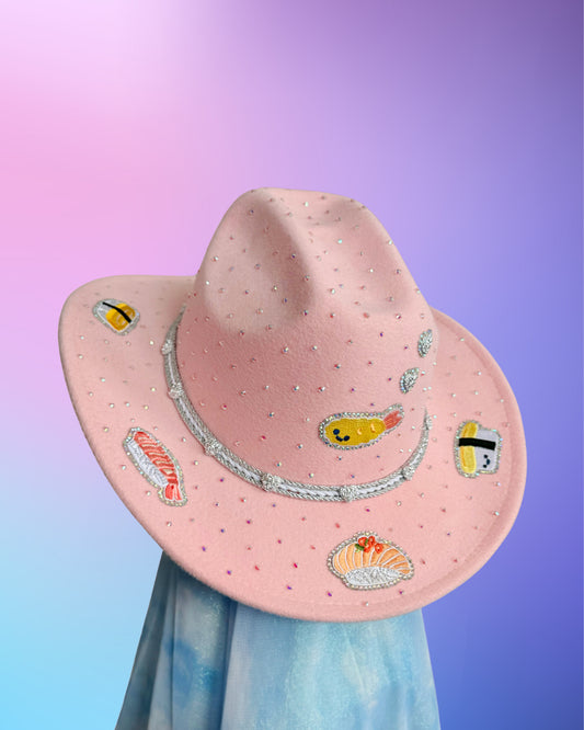 Front view of baby pink sushi cowboy hat with rhinestones and silver cord band.