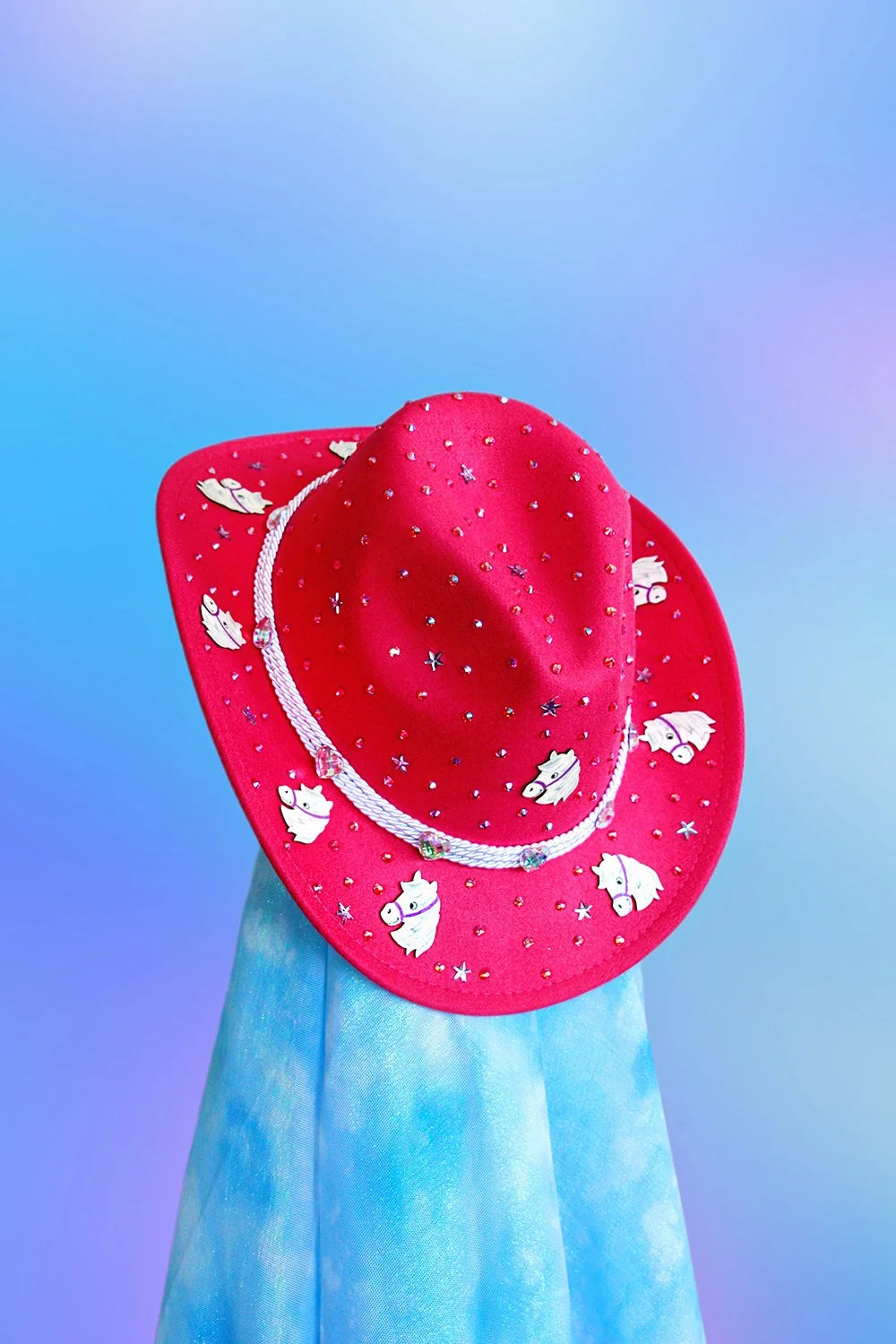 Front view of baby pink sushi cowboy hat with rhinestones and silver cord band.