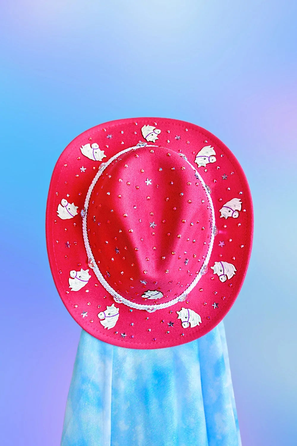 Top view of pink sushi cowboy hat with rhinestones and silver cord band.