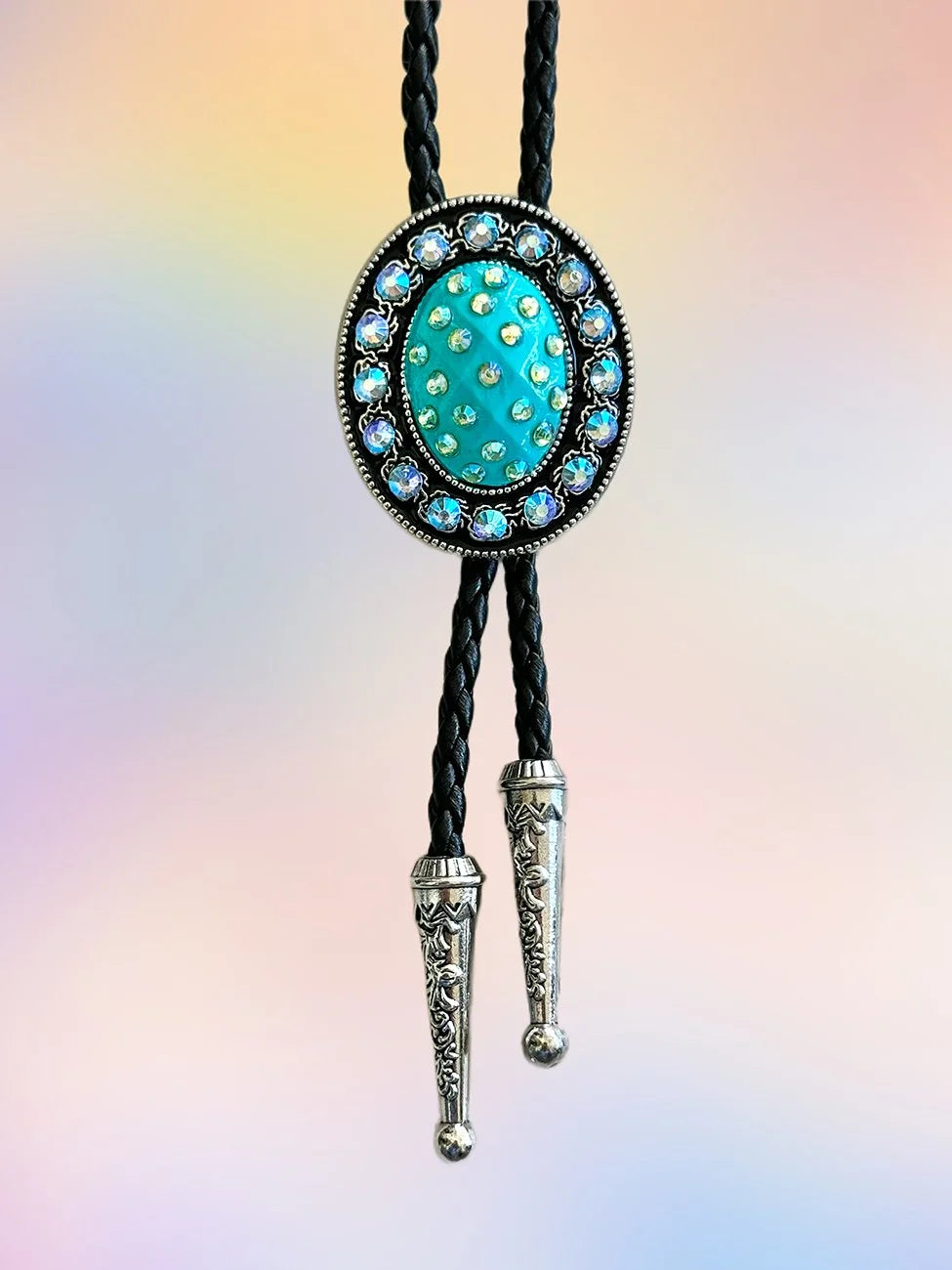 Full front view of the Teal Twilight Bolo Tie with teal rhinestone pendant and engraved silver tips.