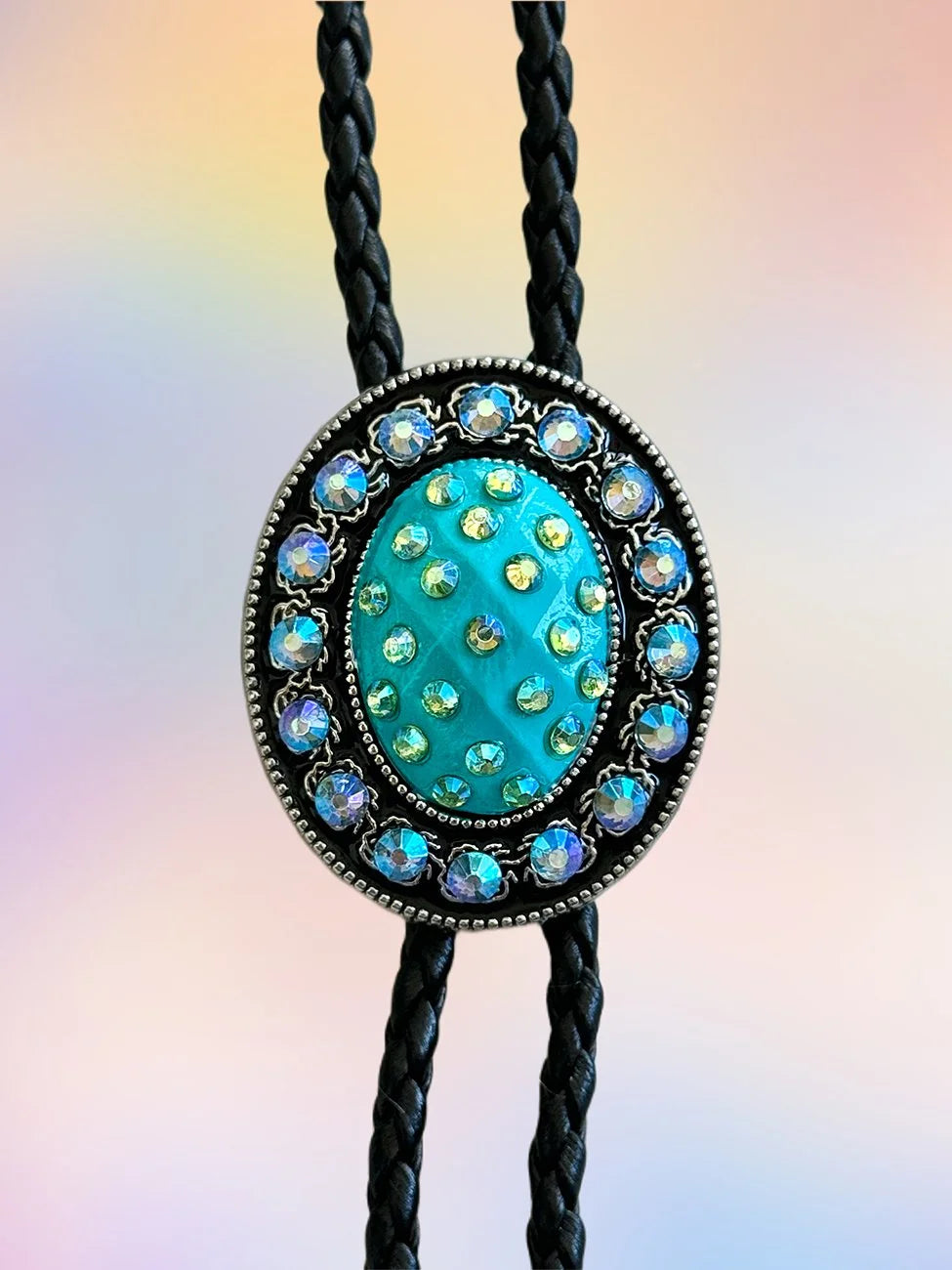 Close-up of the Teal Twilight Bolo Tie pendant with teal paint and blue iridescent rhinestones.