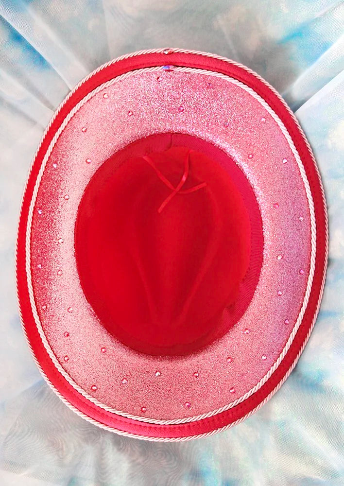 Magenta pink unicorn dream cowboy hat decorated with rhinestones and hearts, bottom view.