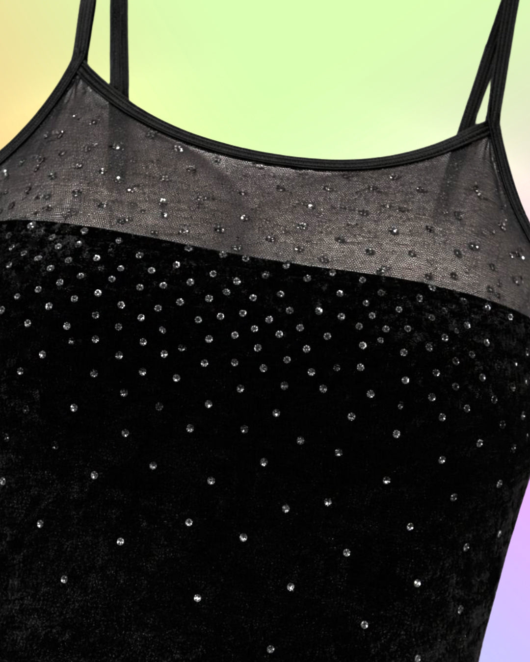 Close-up detail of black velvet fabric with sheer mesh overlay and subtle glitter dot embellishments on a vintage 1990s maxi dress.