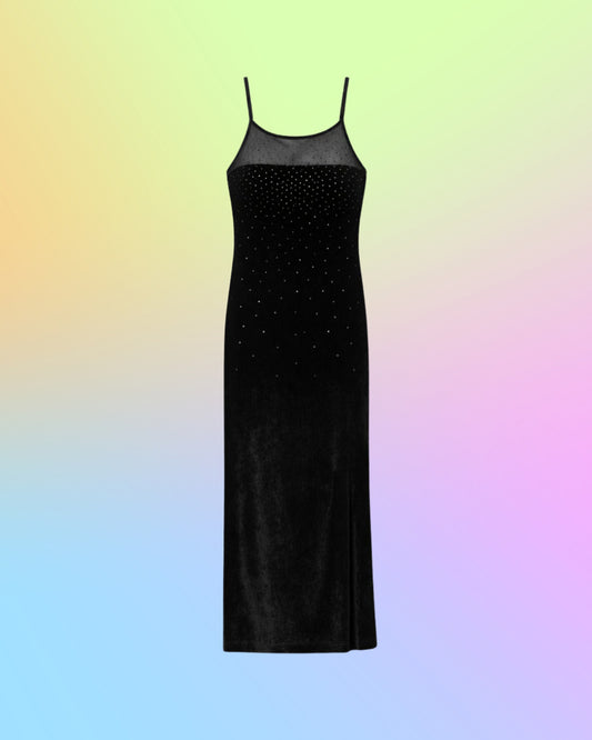 Front view of a vintage 1990s black velvet maxi dress with a sheer mesh neckline and delicate glitter dot embellishments.