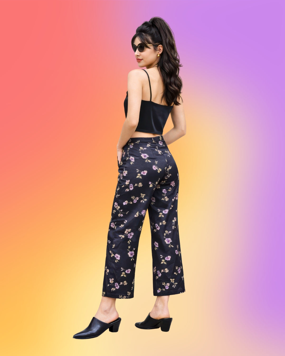 Back view of vintage 1990s Parisian floral satin capri pants on petite model showing cropped length and tailored fit.