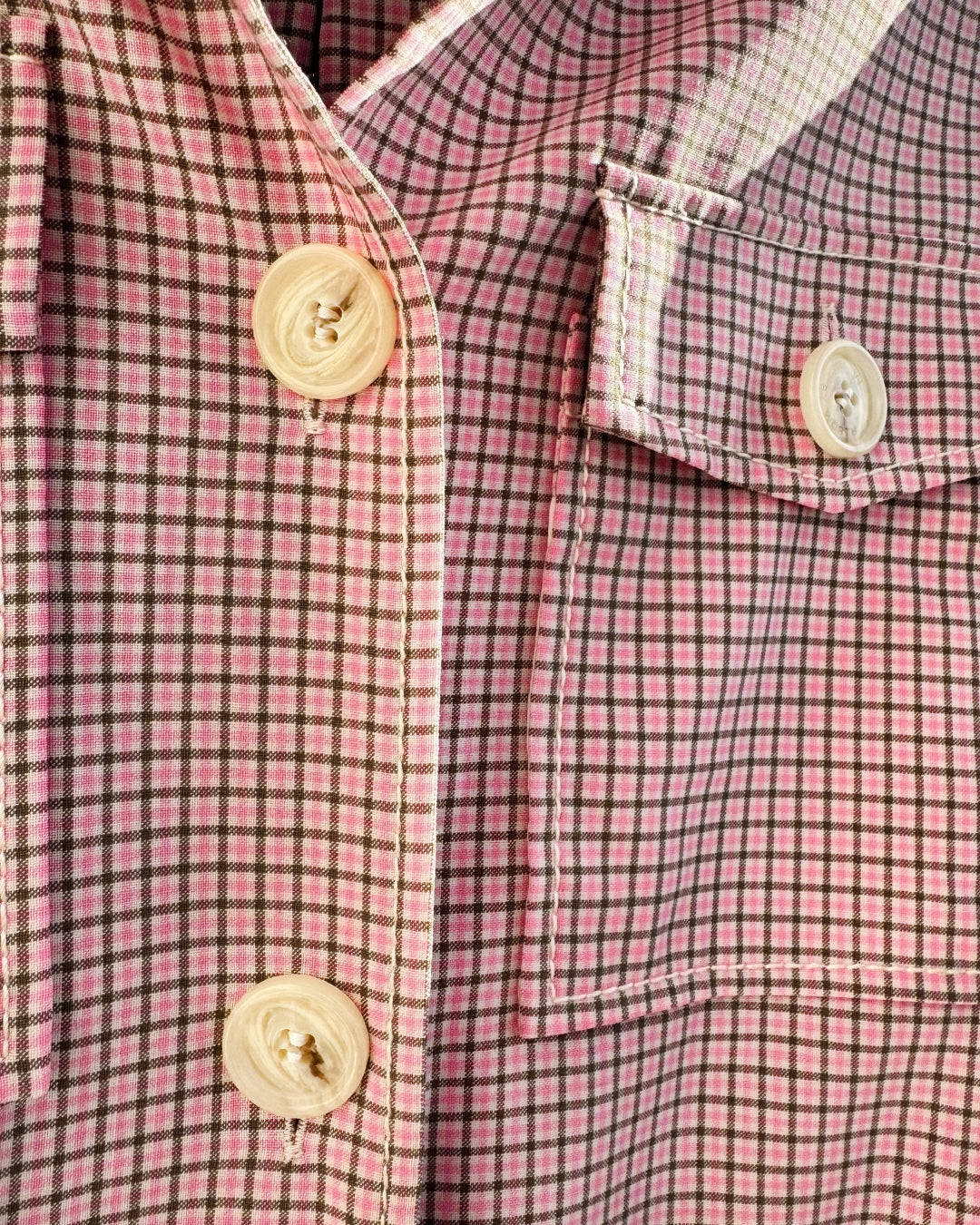 Close-up of soft pink and olive micro-check fabric on vintage W by Worth utility shirt jacket, lightweight woven texture.