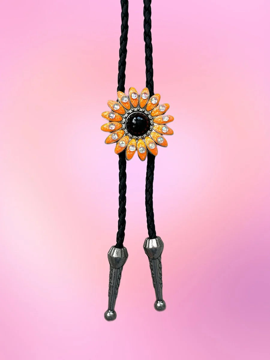 Full view of the Wild Daisy Bolo Tie with neon orange daisy pendant and silver-tone metal tips on a black braided rope.